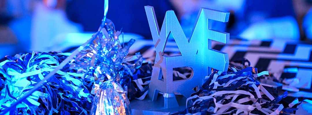 3d-printed "We Are" table centerpiece is surrounded by football shakers on a table